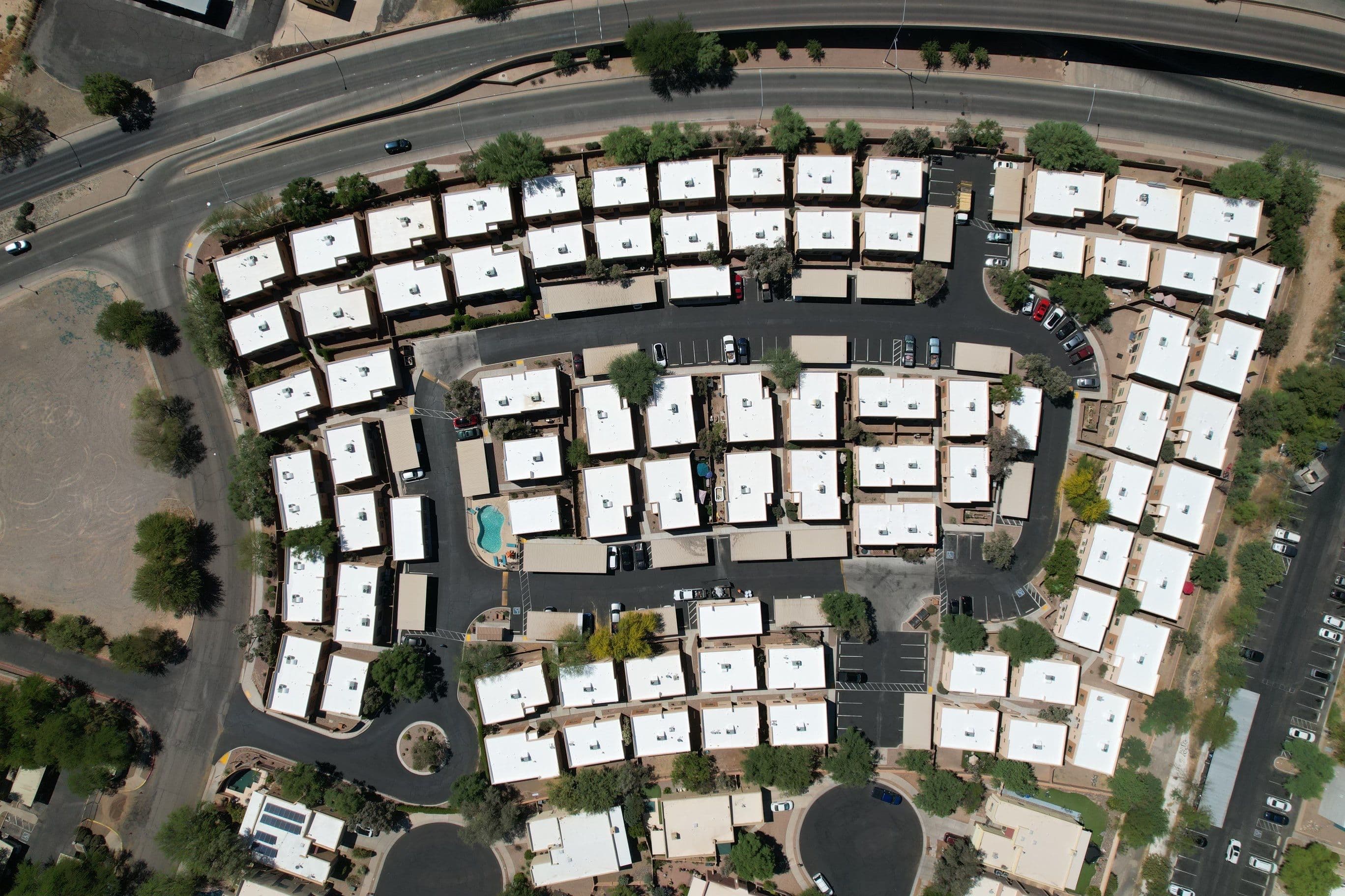 Top-down drone view of multifamily rooftops mid re-roof