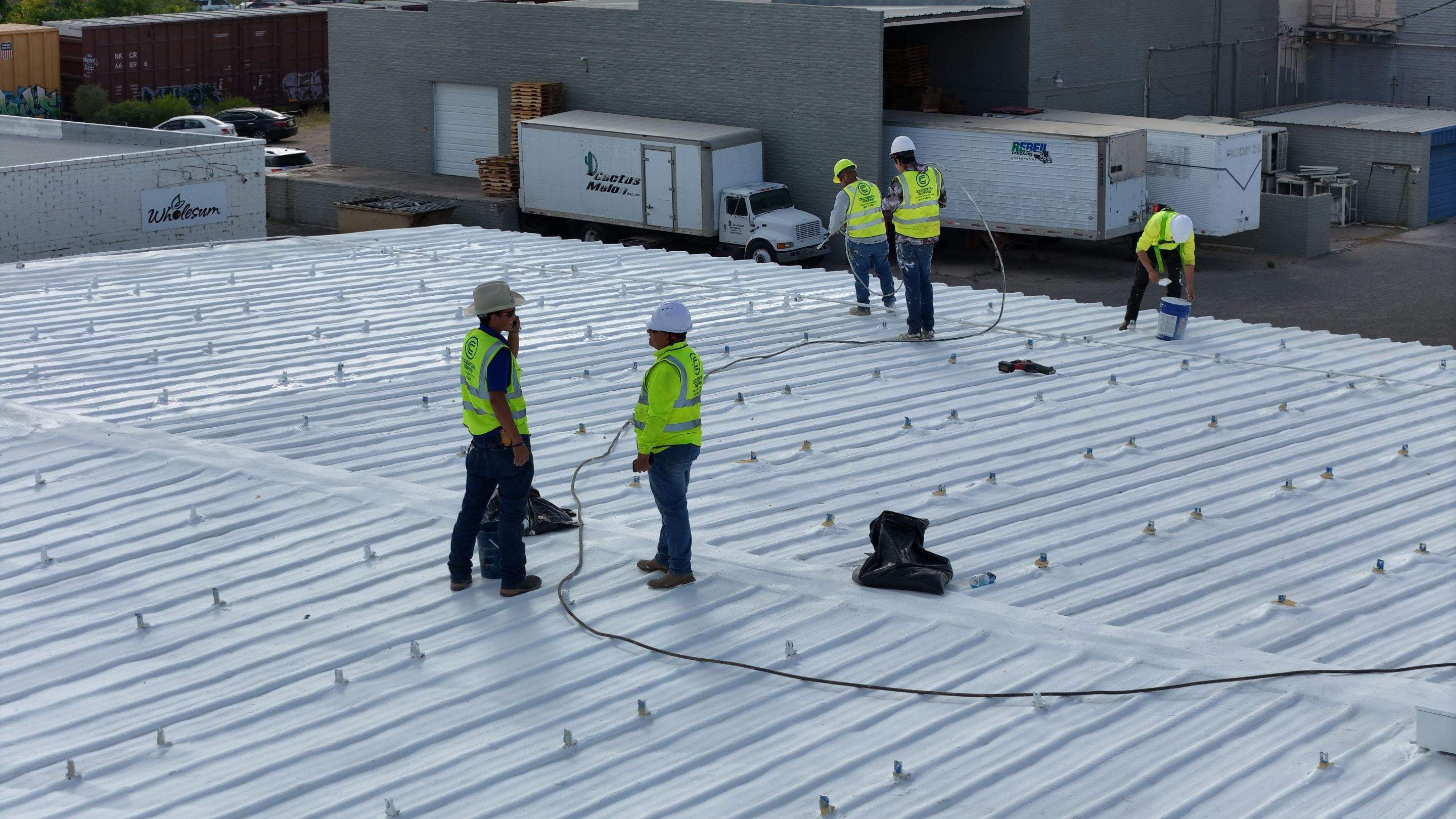 Crew applying a roof coating